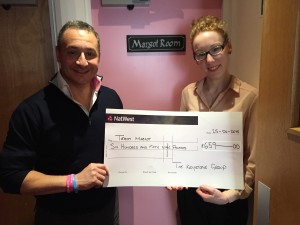 Hostel manager, Orla presents me with a cheque outside the Margot Room